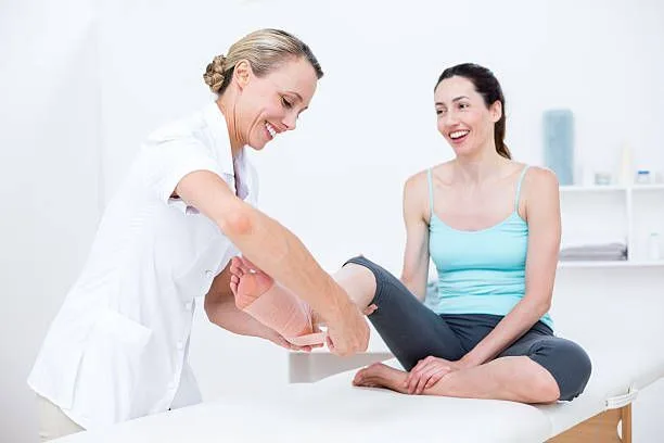 A woman receives a foot examination from a doctor, assessing a sprain injury for proper treatment and care.