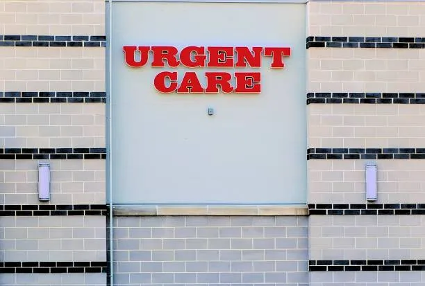 "Urgent Care" in red letters on a building wall